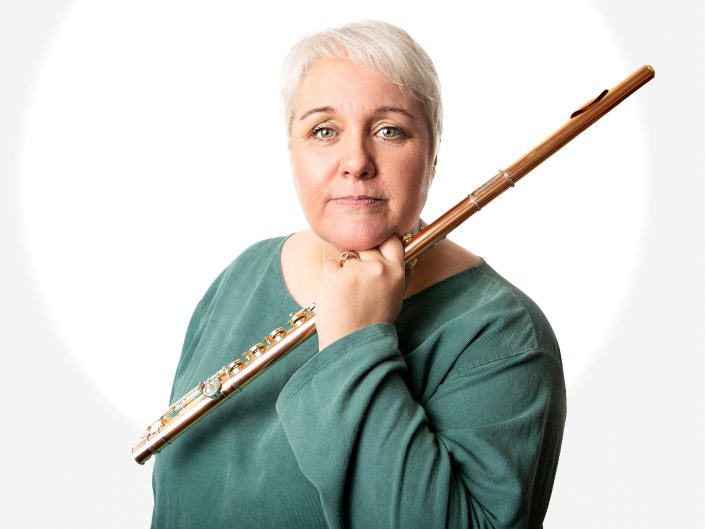 Flutist Nikki Warrington showing her natural glow during her corporate portrait session in the studio.